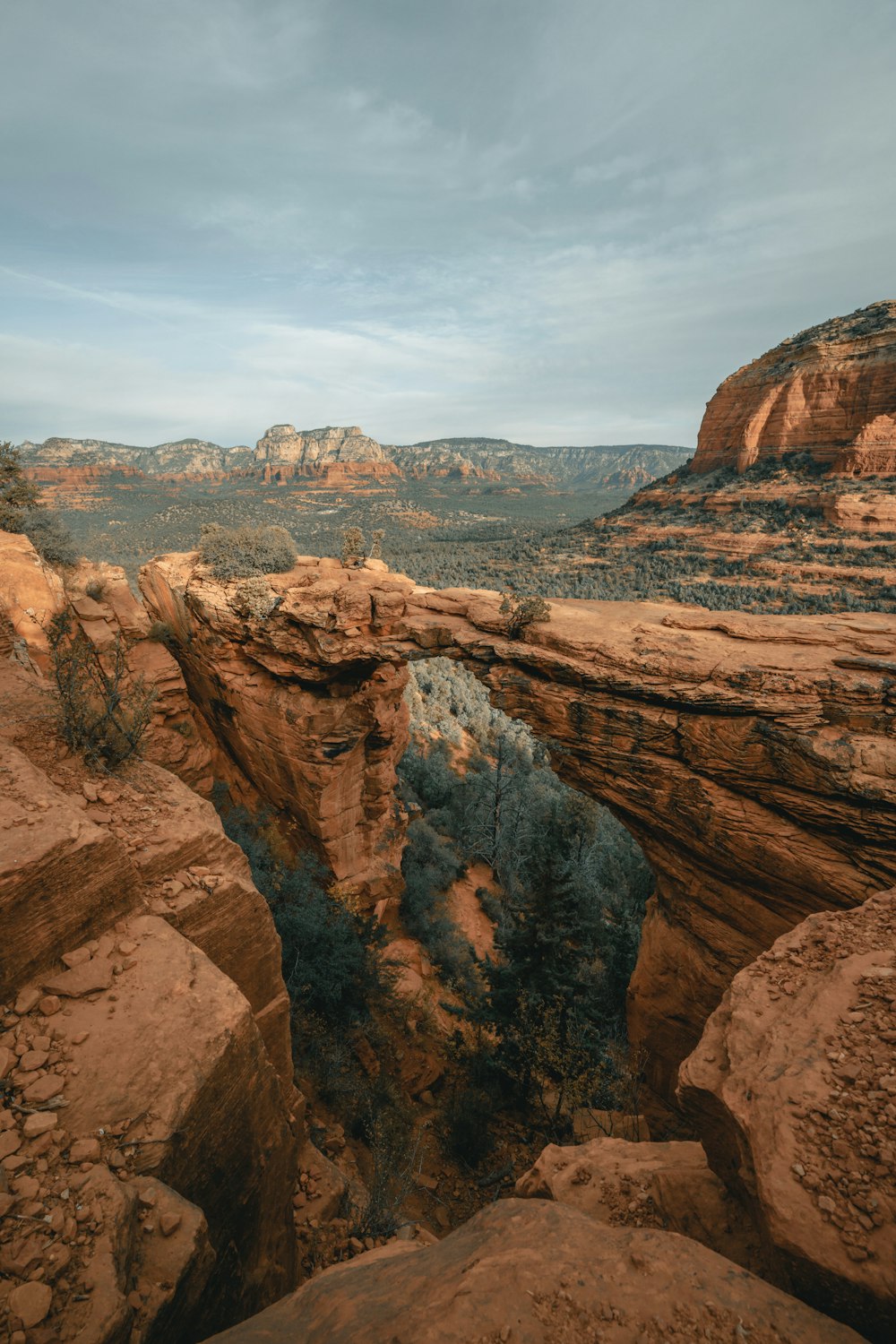 brown rock formation under white clouds during daytime