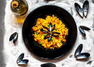 yellow flowers on black round plate