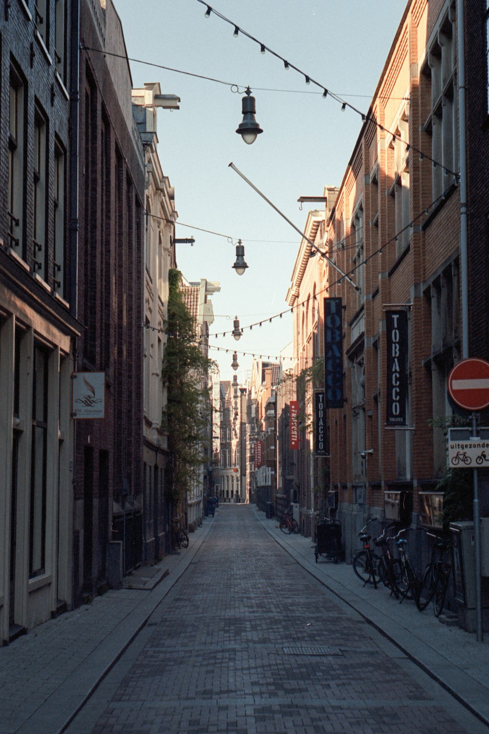 a city street lined with tall brick buildings