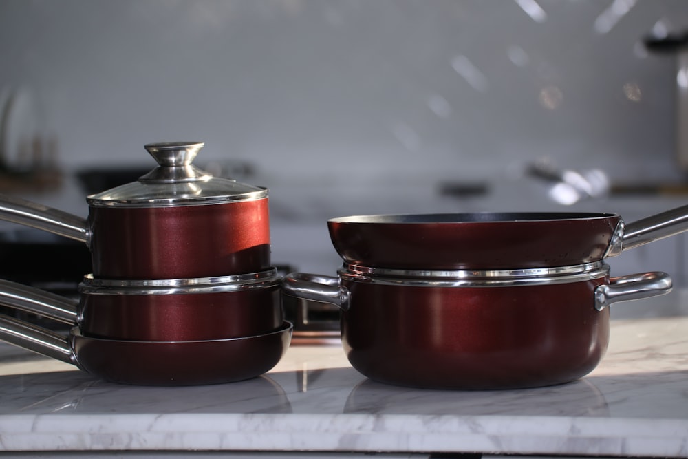 red and silver steel cooking pots