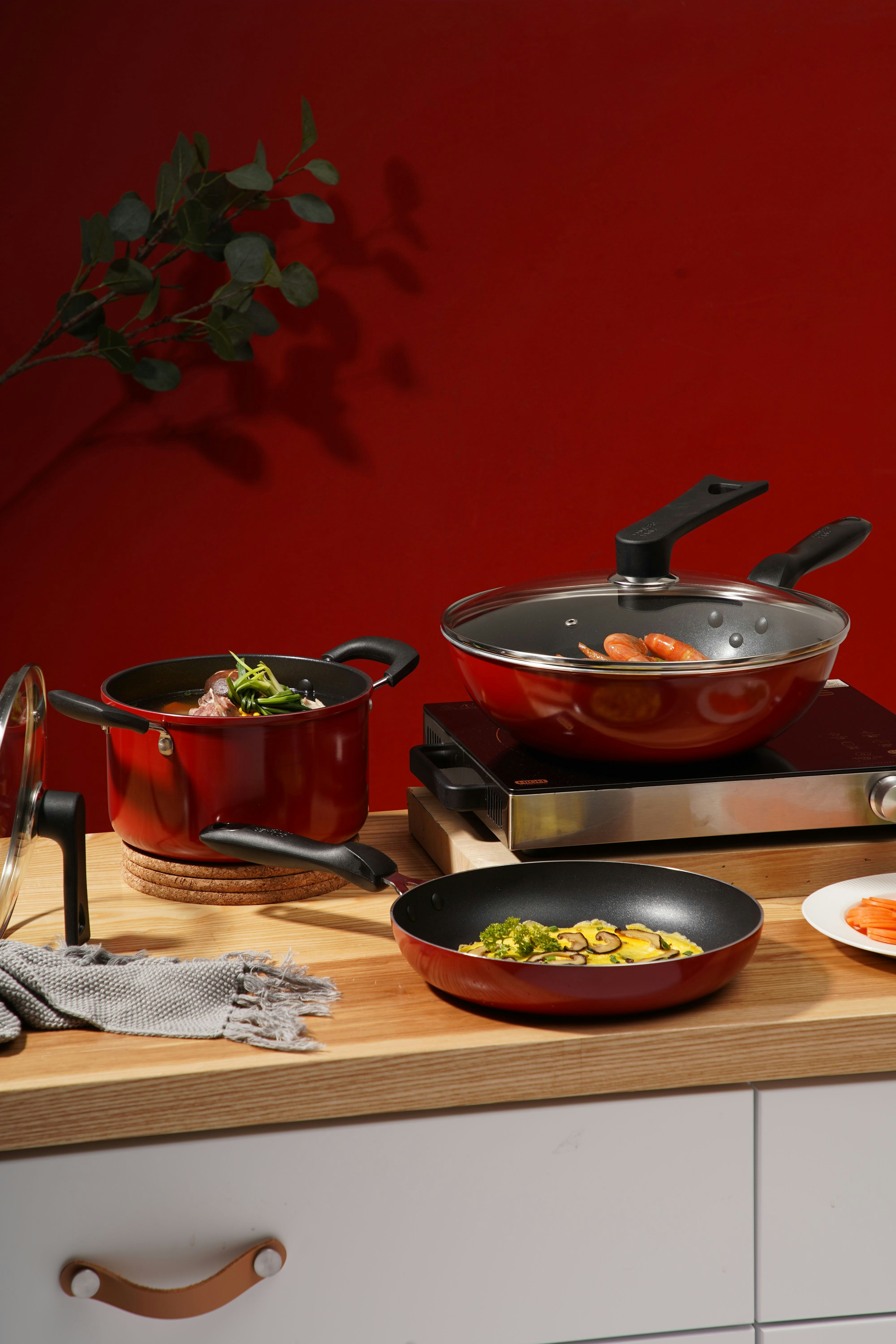 Red and black cooking pot on brown wooden table photo – Free Brown ...