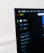 A computer screen displays the Spotify application, showing menu options such as Home, Browse, Radio, and Your Library, which includes Made For You, Recently Played, and Liked Songs. The application interface is sleek, with a dark background and white text, alongside green, yellow, and red window control buttons at the top left.