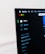 A computer screen displays the Spotify application, showing menu options such as Home, Browse, Radio, and Your Library, which includes Made For You, Recently Played, and Liked Songs. The application interface is sleek, with a dark background and white text, alongside green, yellow, and red window control buttons at the top left.