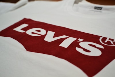 A white T-shirt featuring the iconic red Levi's logo prominently printed across the front.
