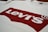 A white T-shirt featuring the iconic red Levi's logo prominently printed across the front.