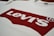 A white T-shirt featuring the iconic red Levi's logo prominently printed across the front.