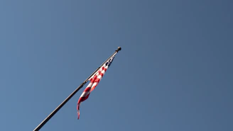 Ohio state flag waving gently against a clear blue sky.