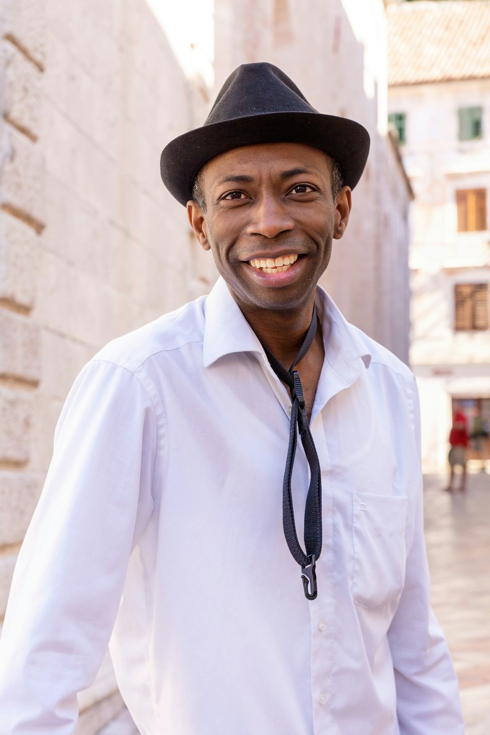 man in white dress shirt wearing black fedora hat