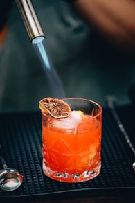 Vibrant orange liqueur bottle with sliced oranges and a price label of $28