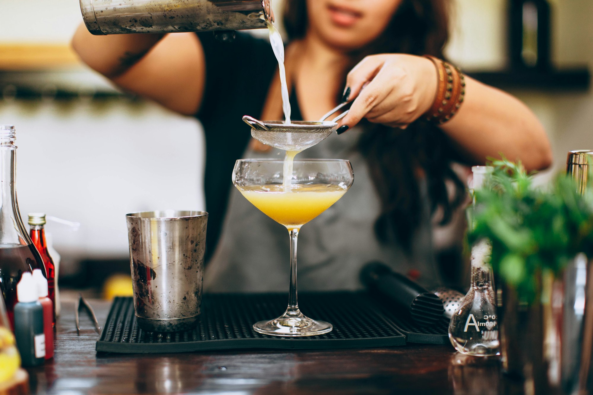 A bartender pours a happy hour cocktail