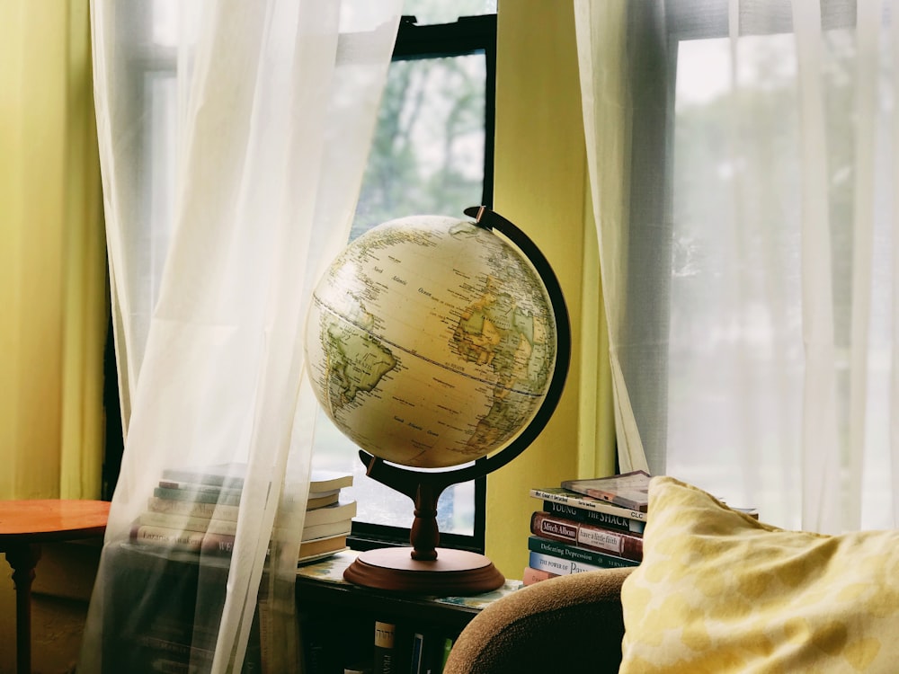 white and black desk globe on brown wooden table