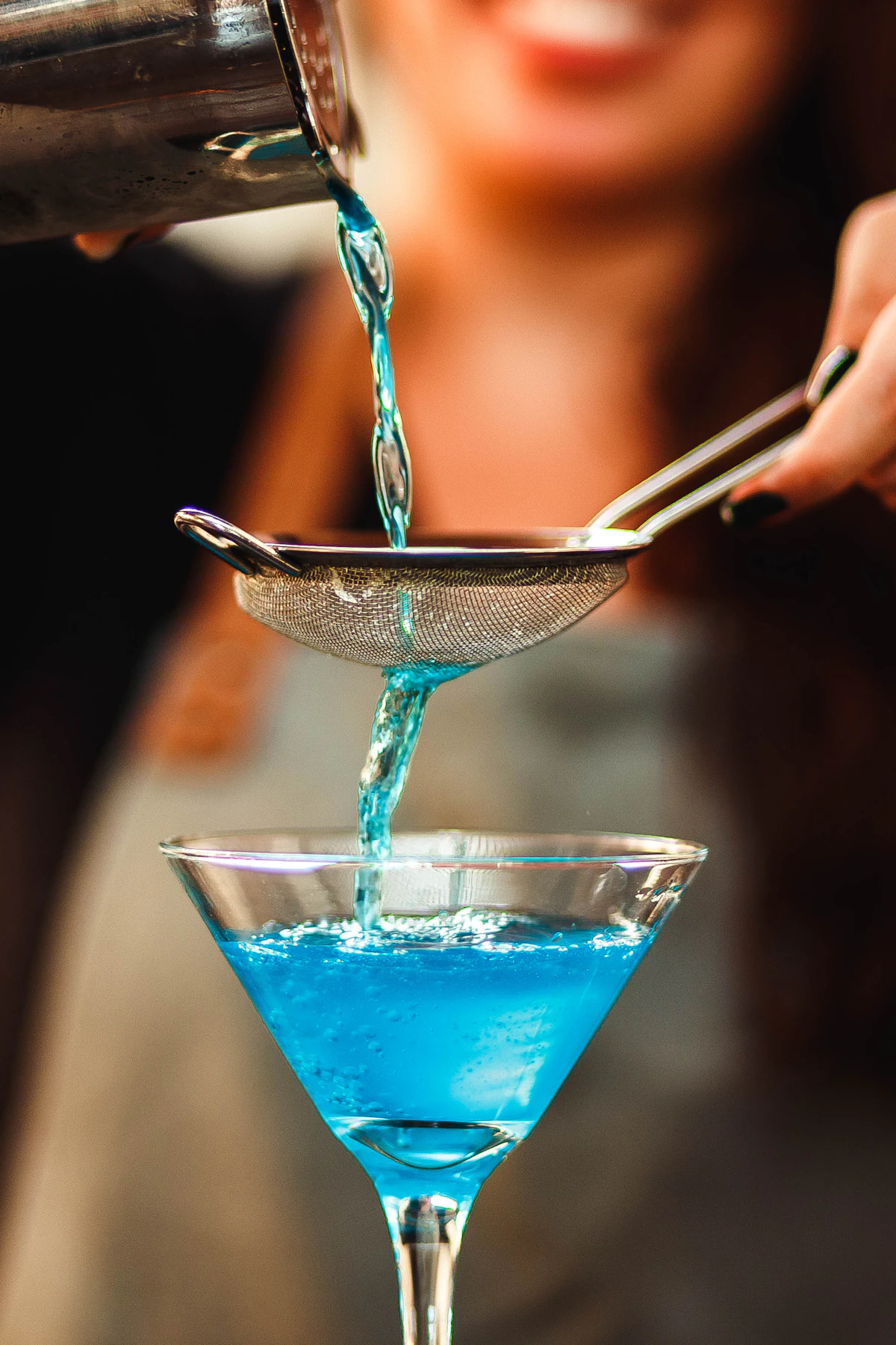 Styled cocktail in elegant glass against moody dark background