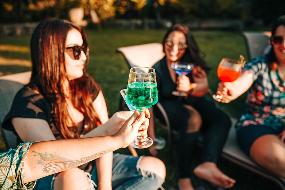 woman in black tank top holding wine glass