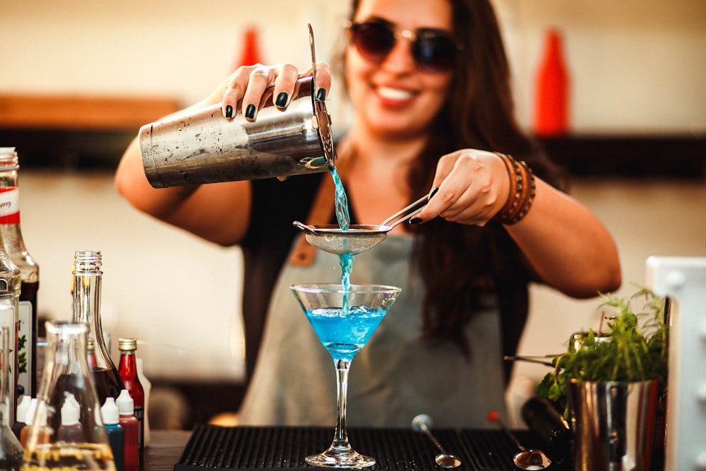 woman in black tank top holding cocktail glass