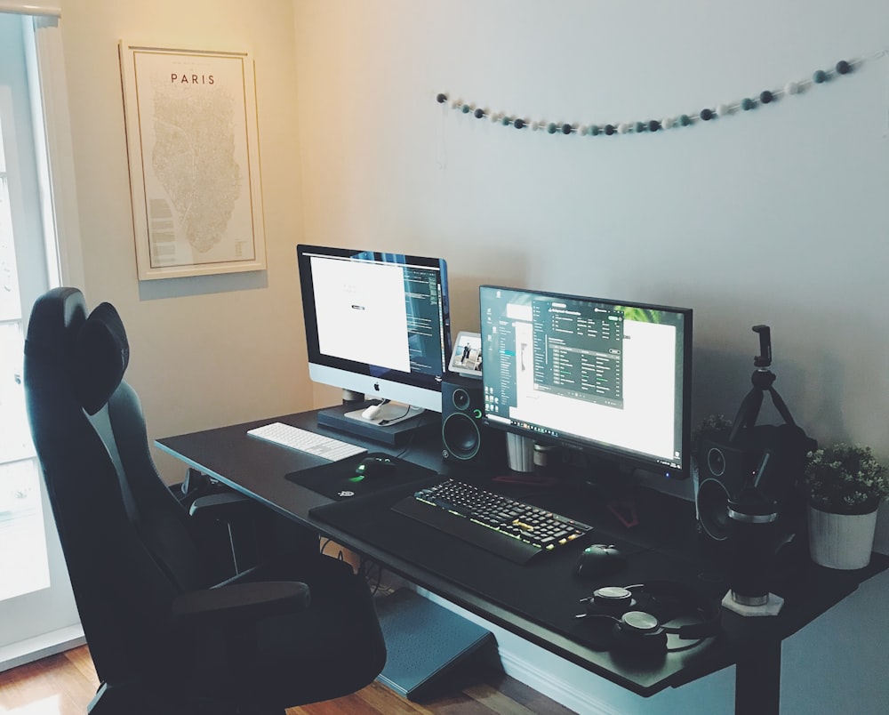 black flat screen computer monitor on brown wooden desk