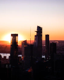 A city skyline featuring commercial office buildings during sunset.