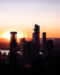 City skyline featuring commercial buildings during sunset.