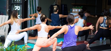 woman in white tank top and pink leggings doing yoga