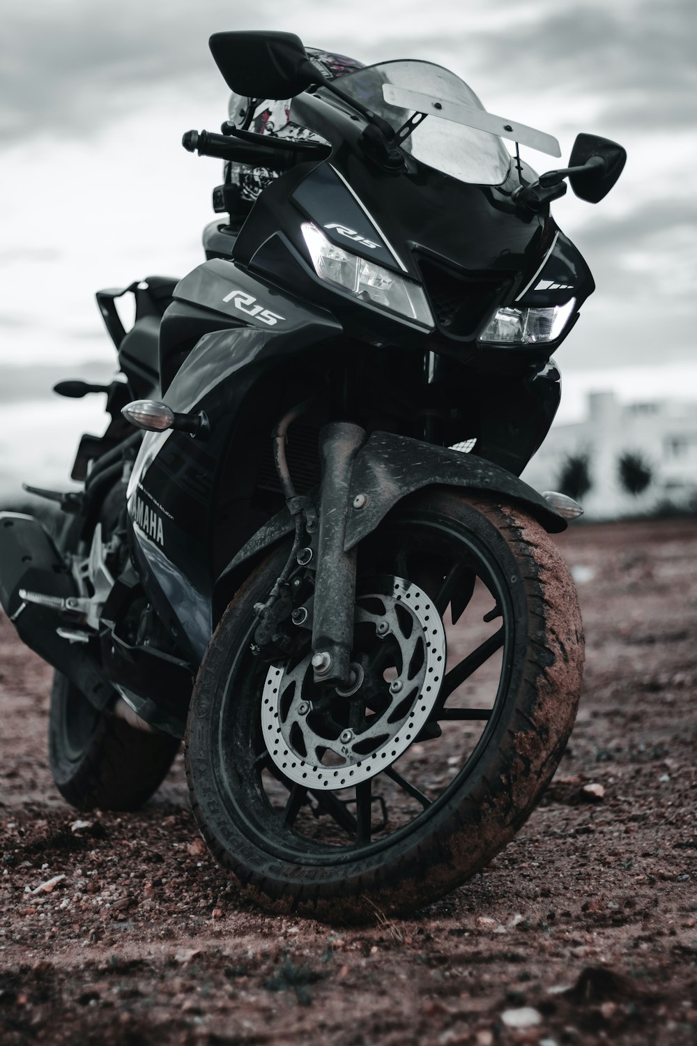 black sports bike on brown dirt road during daytime