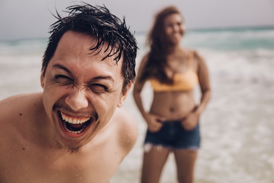 smiling man in blue shorts on beach during daytime in Boracay Island Philippines