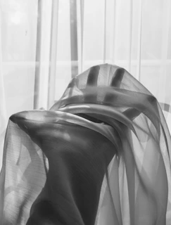 grayscale photo of a person wearing a striped shirt