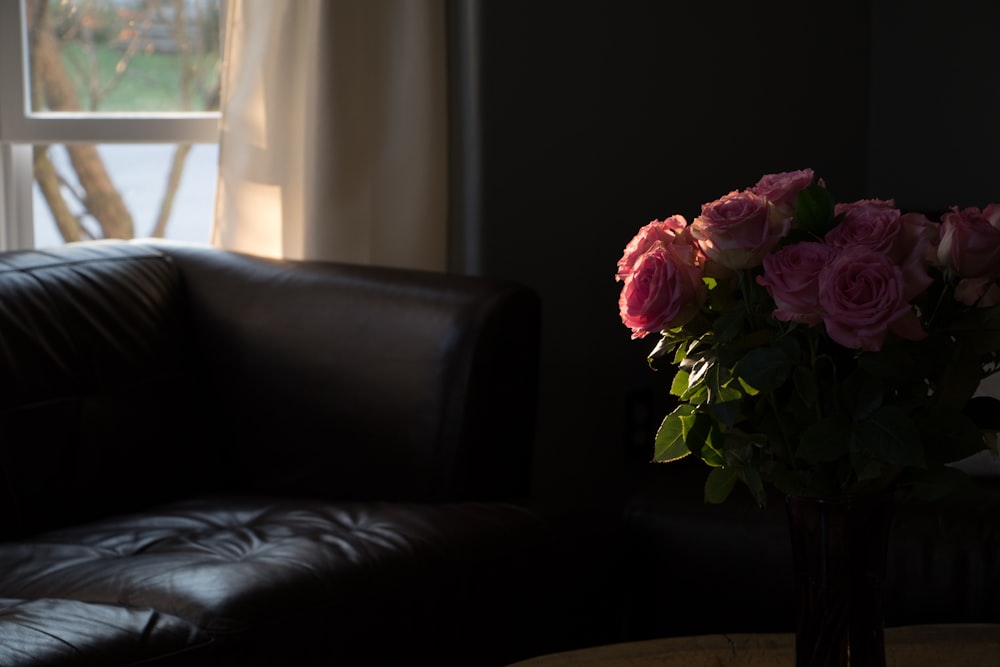 pink roses on black sofa