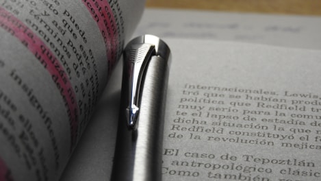 Close-up of a hand highlighting key points on a printed academic text.