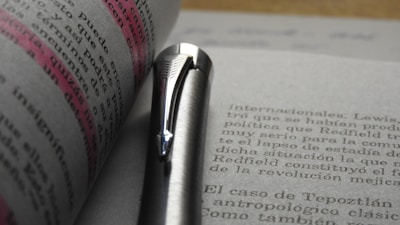 Close-up of a legal document with highlighted text and a pen resting on it.