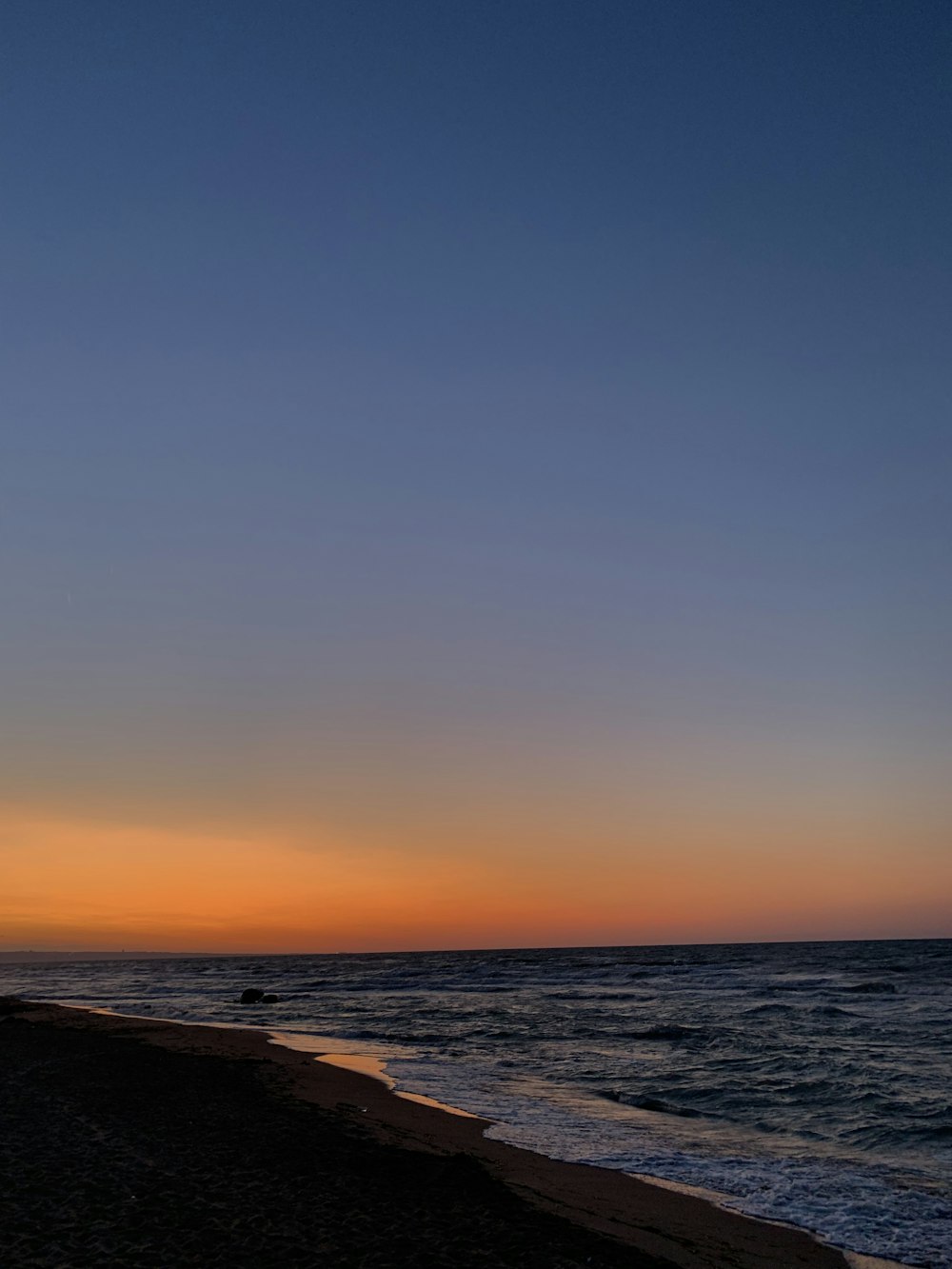 body of water during sunset