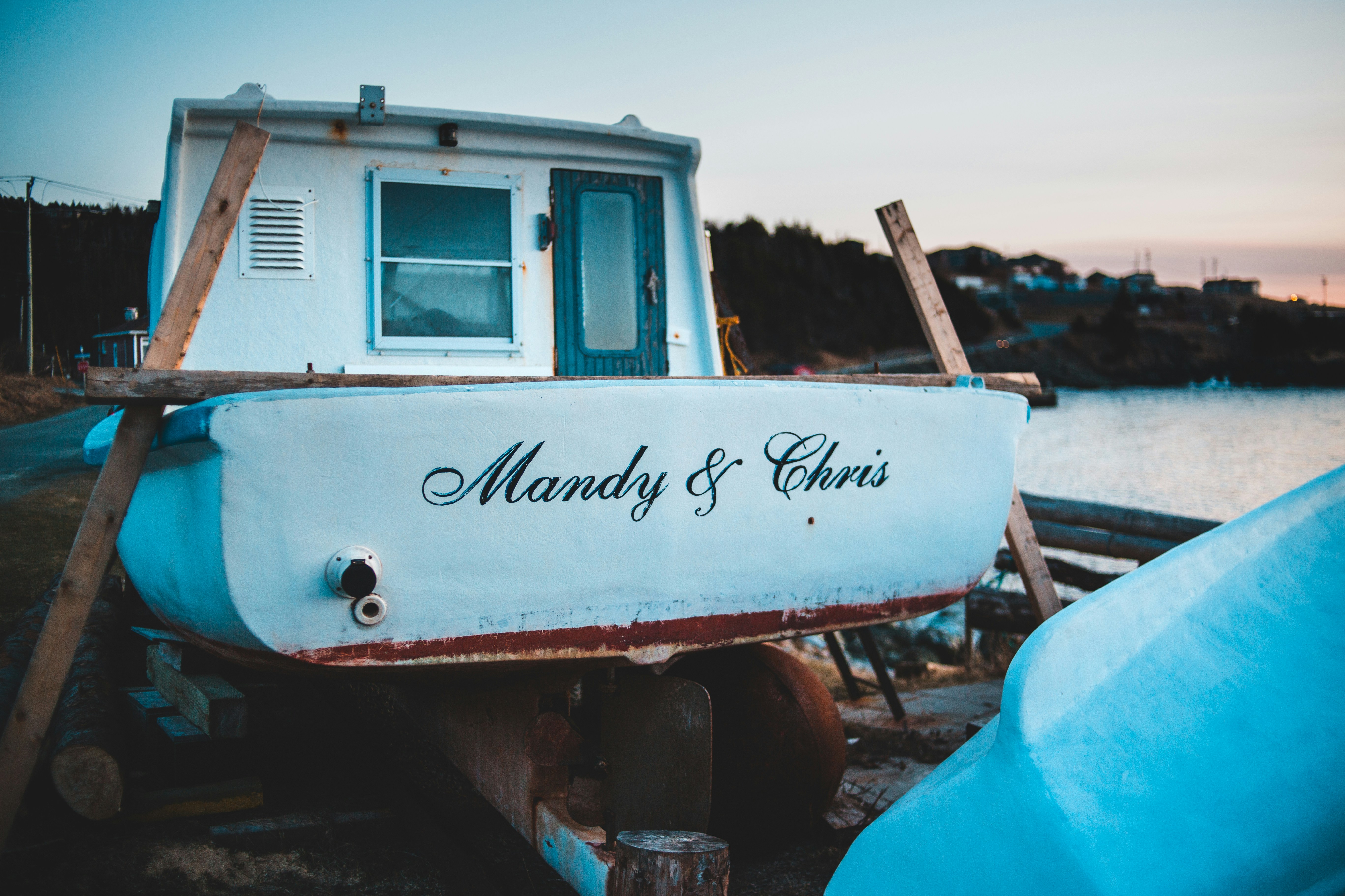 Variety of boat hull types at a marina showing name placements