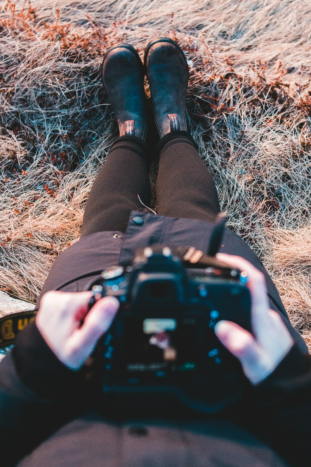 person holding black dslr camera