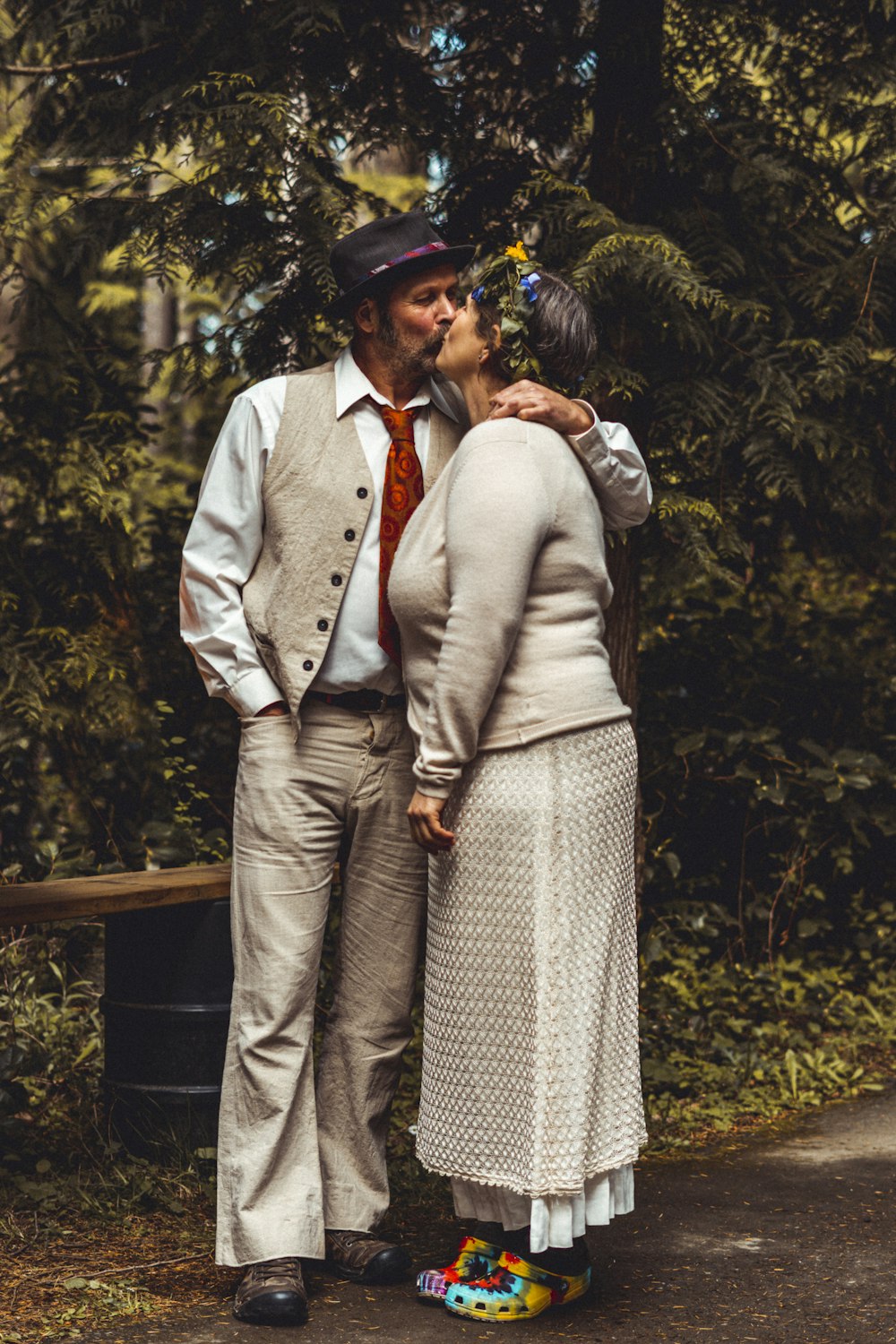 man in gray suit jacket and woman in gray long sleeve dress standing on brown wooden