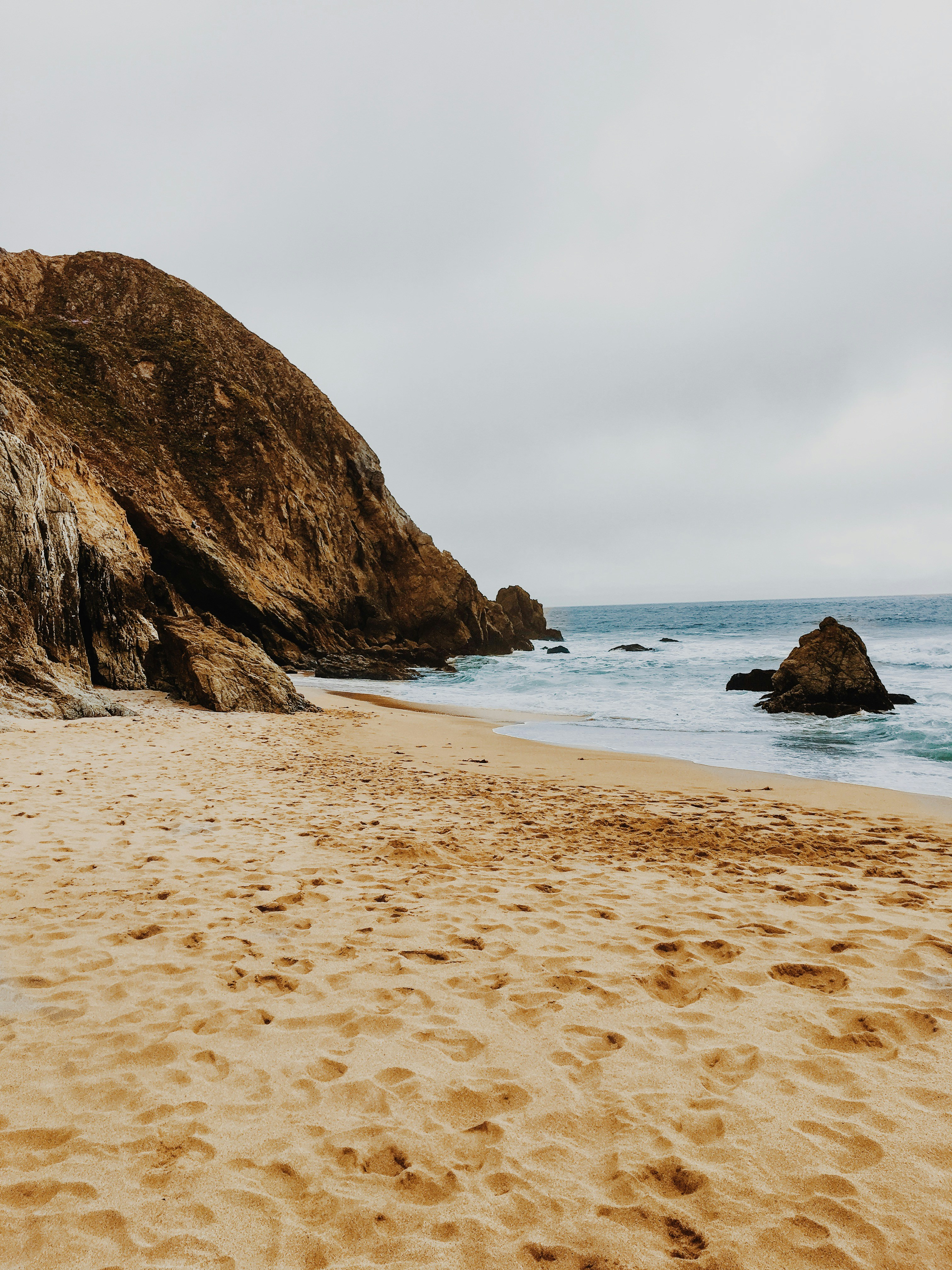 brown rock formation on sea shore during daytime
