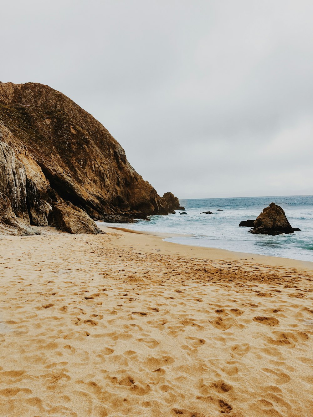 brown rock formation on sea shore during daytime