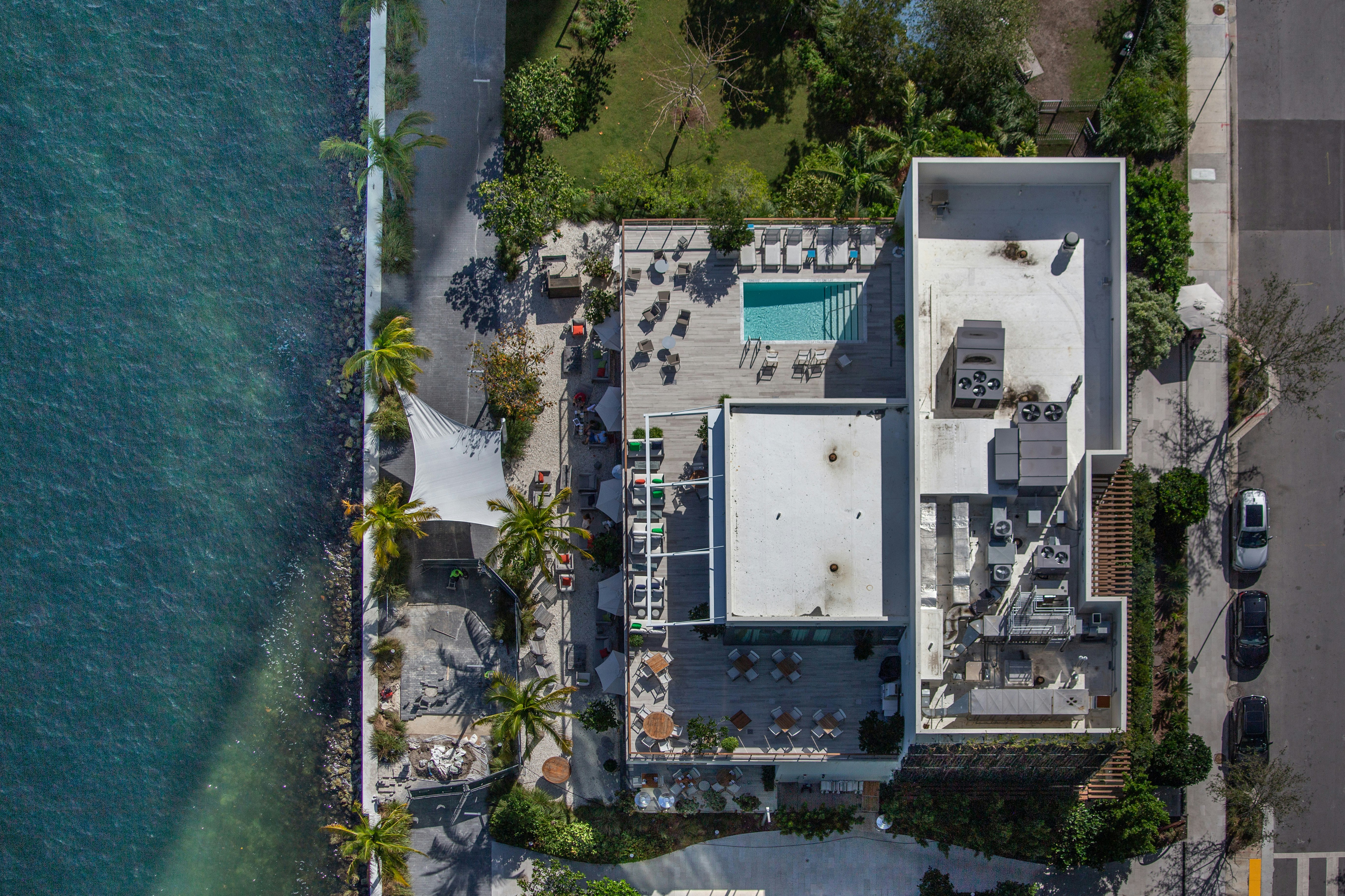 aerial view of white and blue building near body of water during daytime