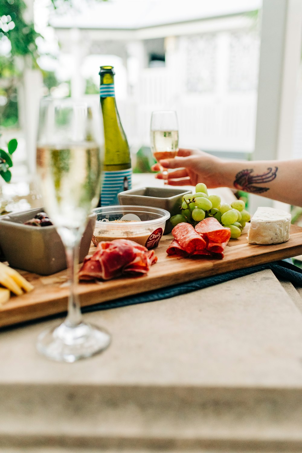 person holding a tray with fruits and vegetable salad