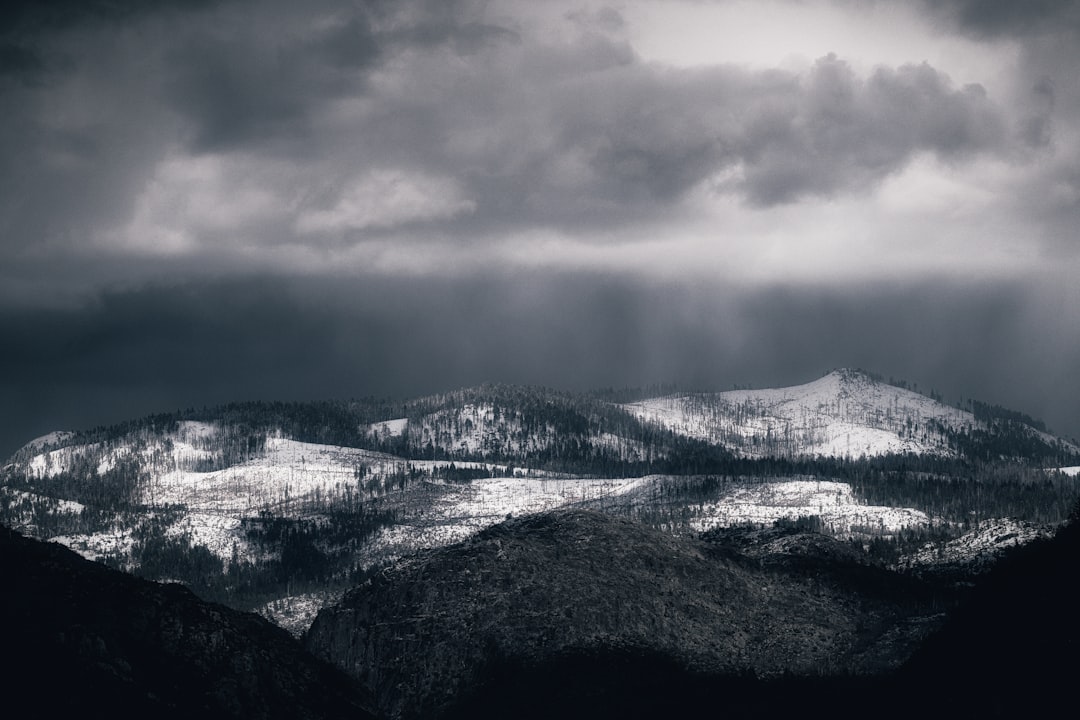 snow covered mountain under cloudy sky during daytime