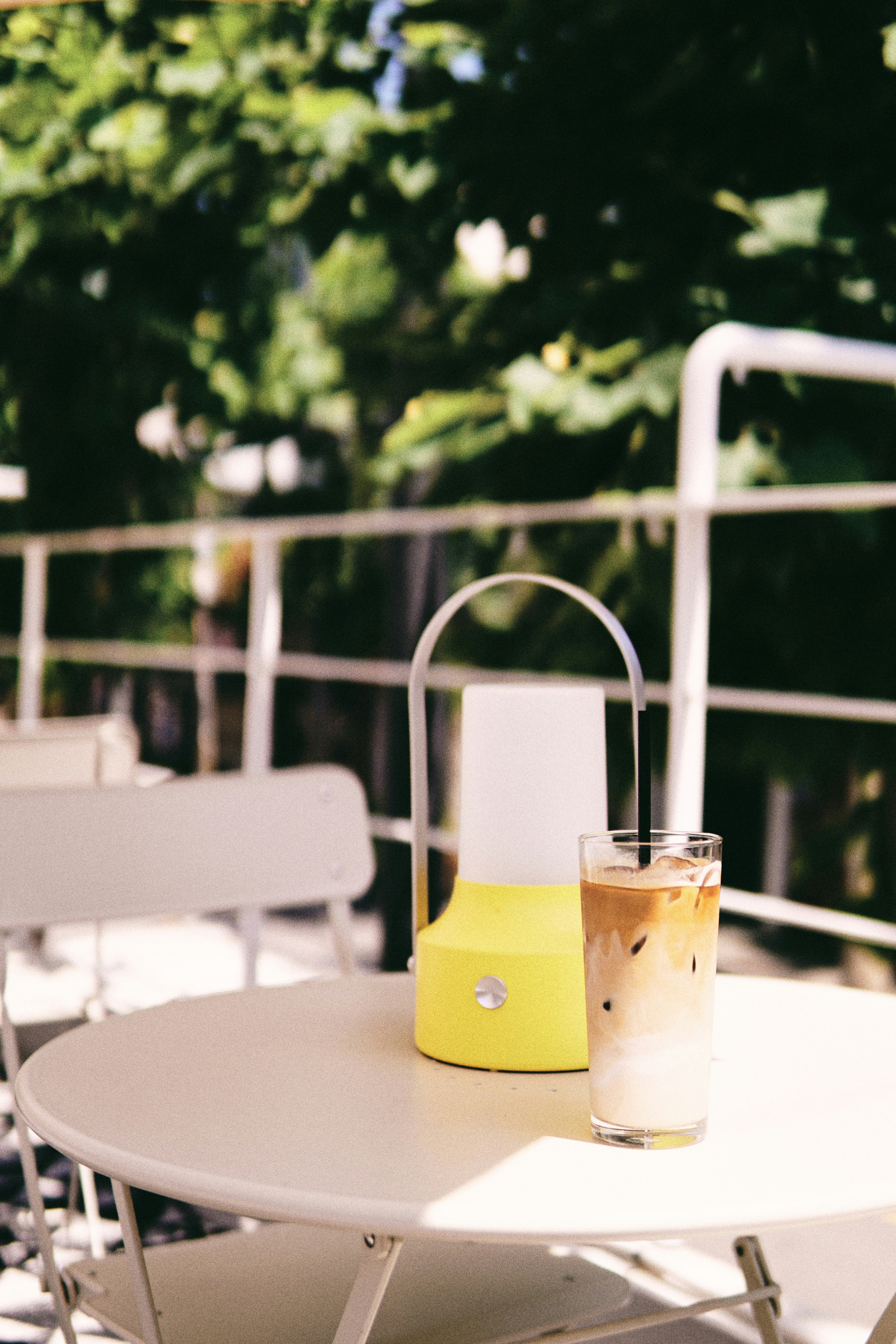 yellow and white ceramic mug on white table