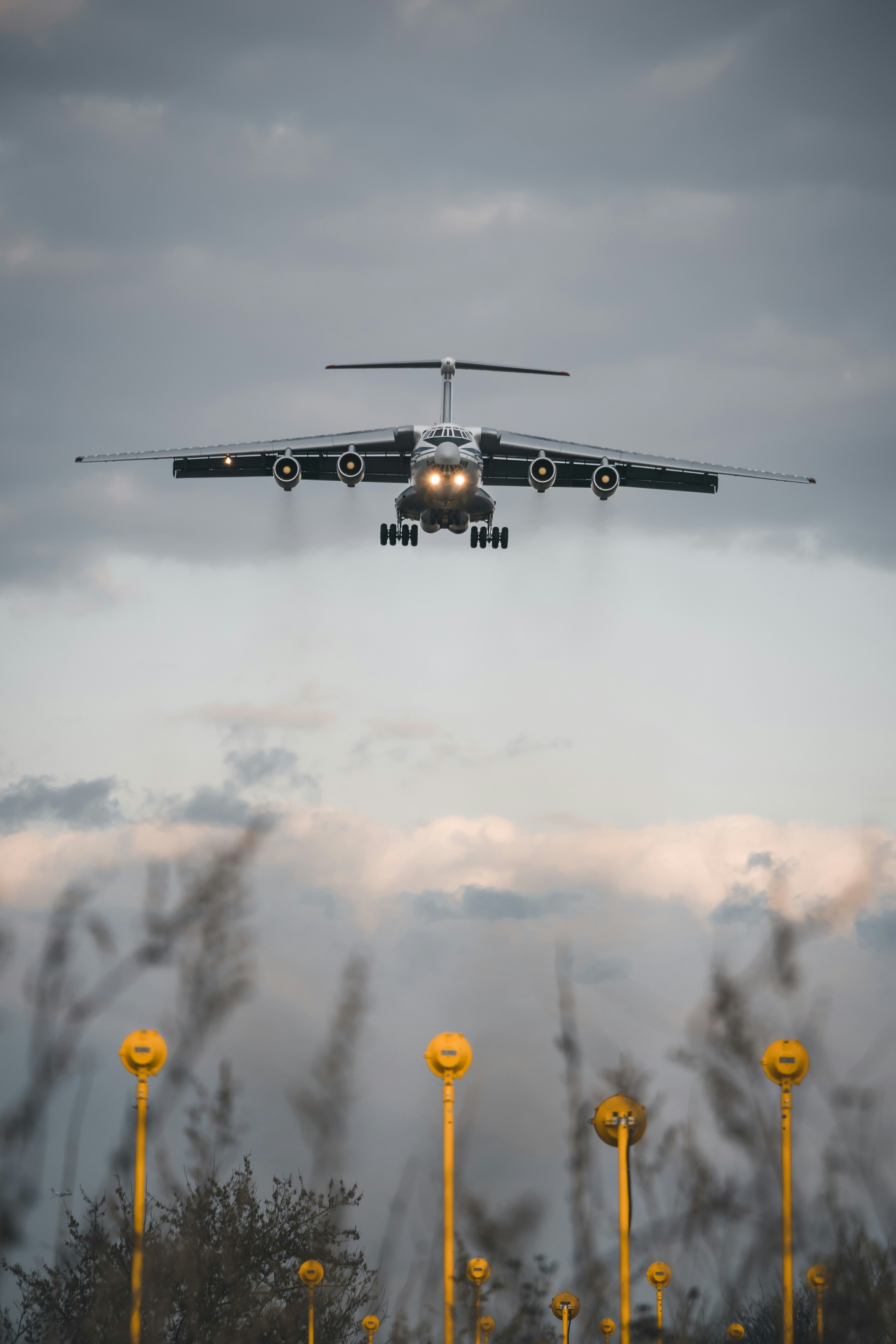 black helicopter flying over the clouds during daytime