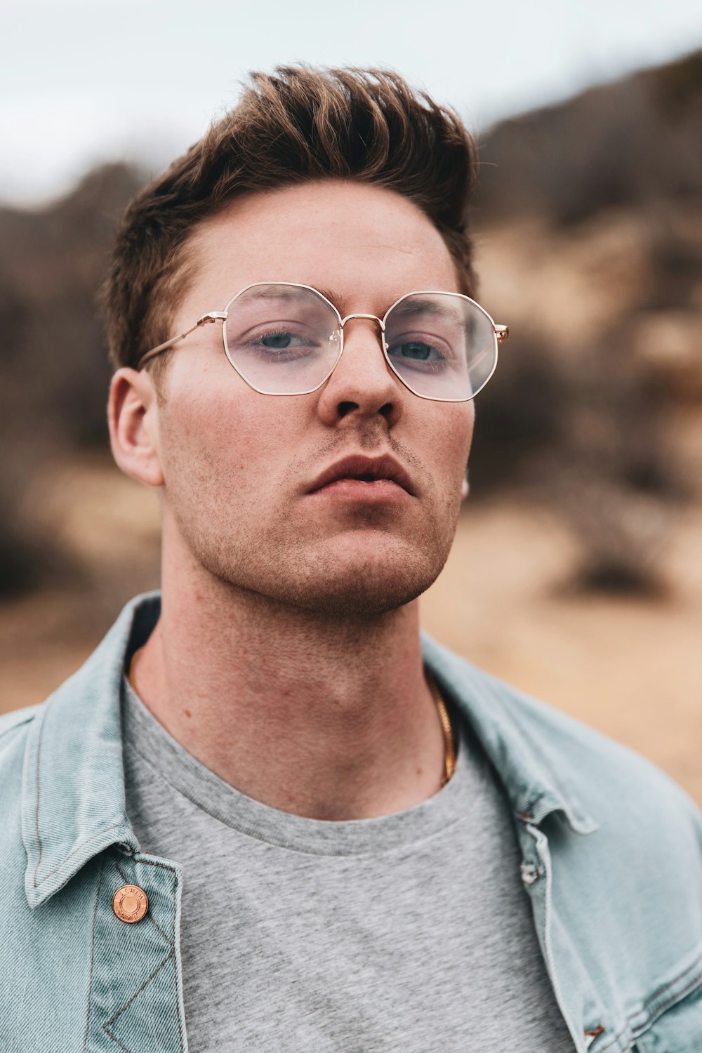 man in gray crew neck shirt wearing eyeglasses