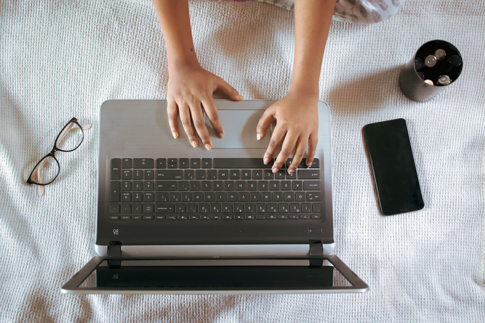 person using black and gray laptop computer