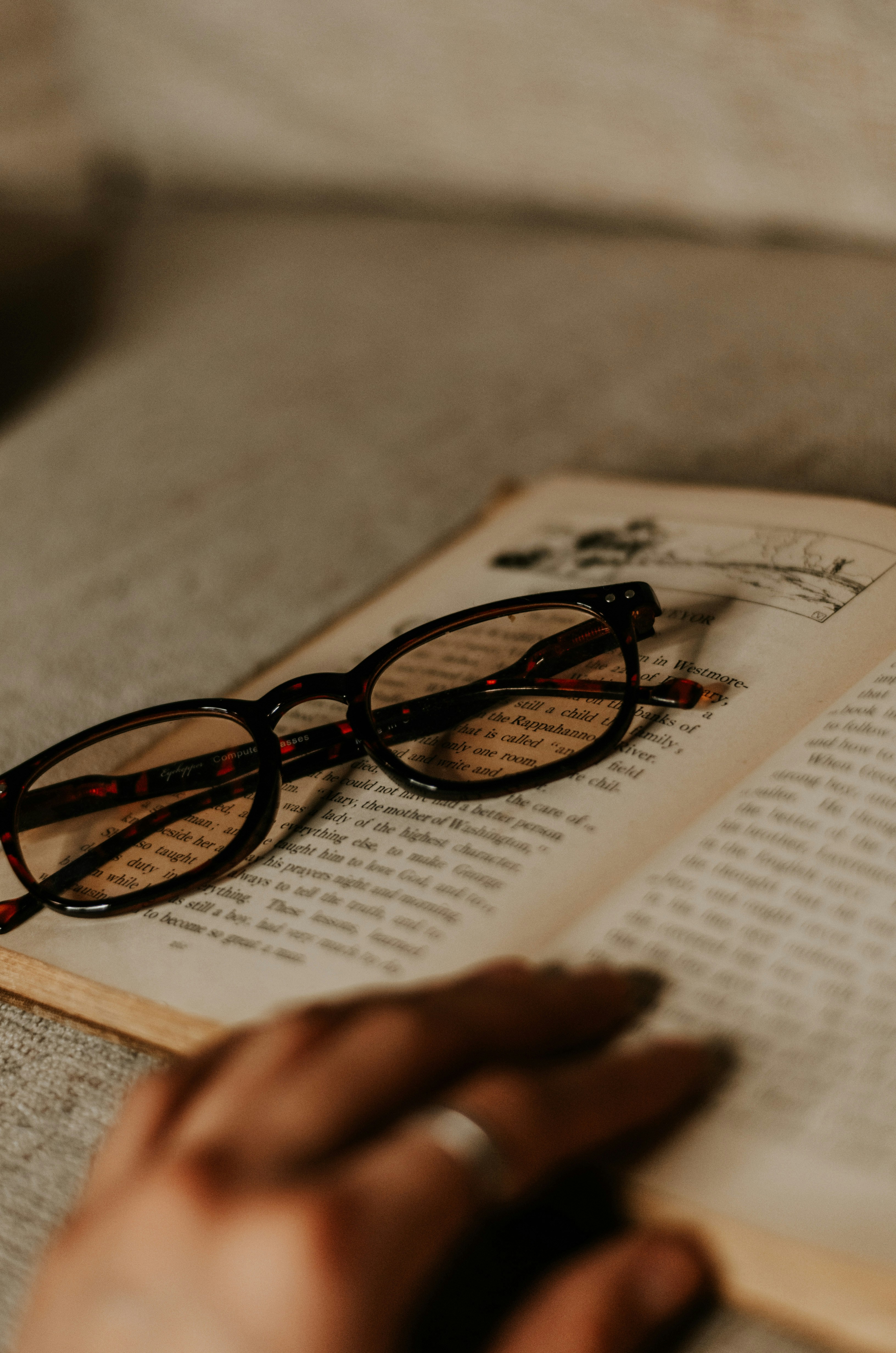 black framed eyeglasses on white printer paper