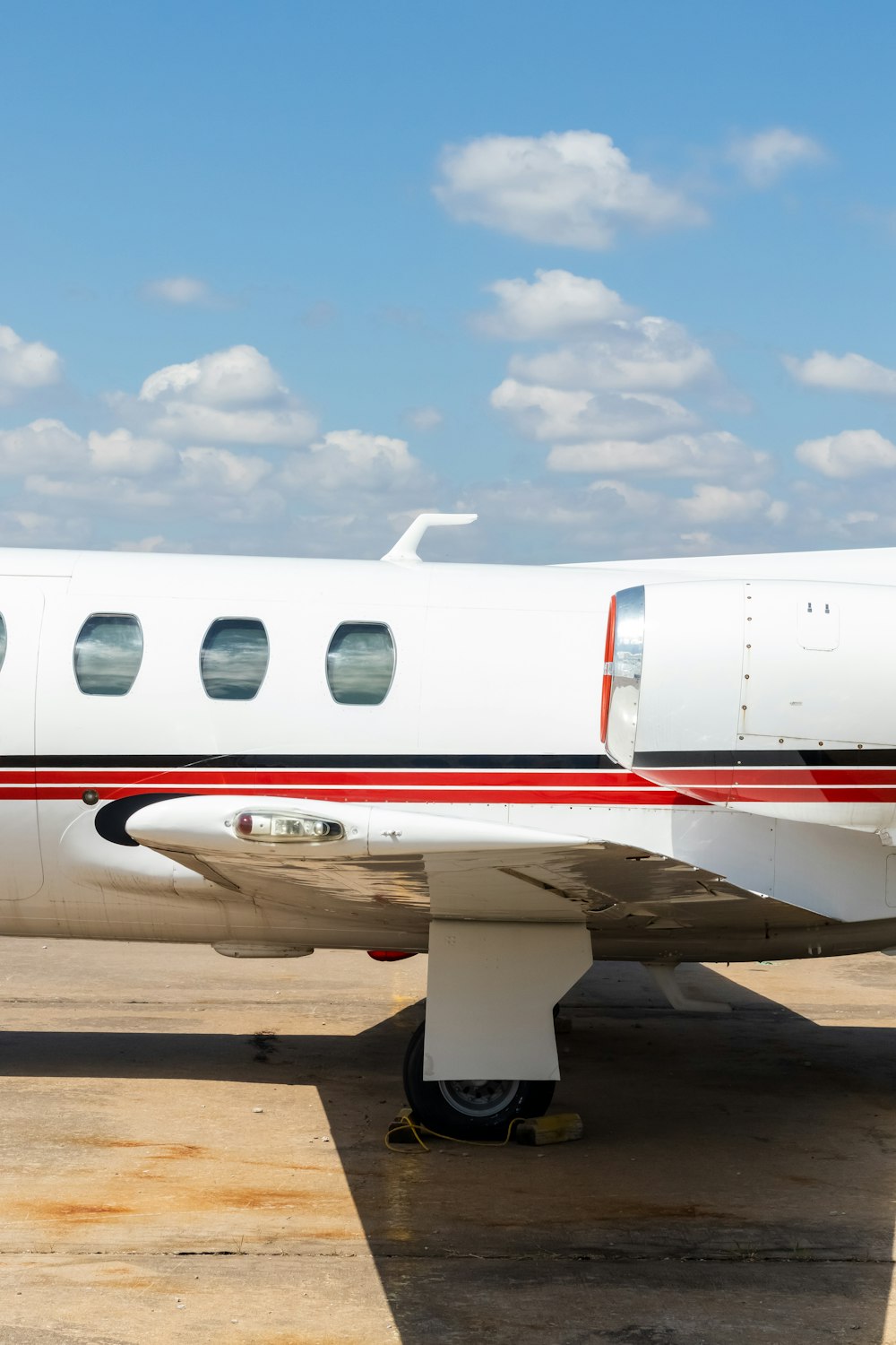 white and red airplane under blue sky during daytime