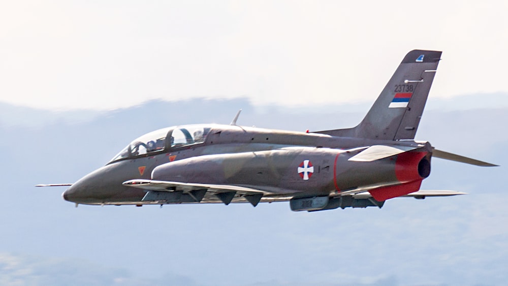 black jet plane in mid air during daytime