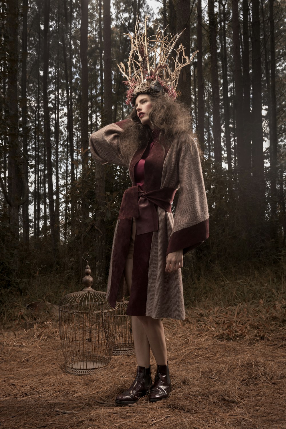 woman in red coat standing on forest during daytime