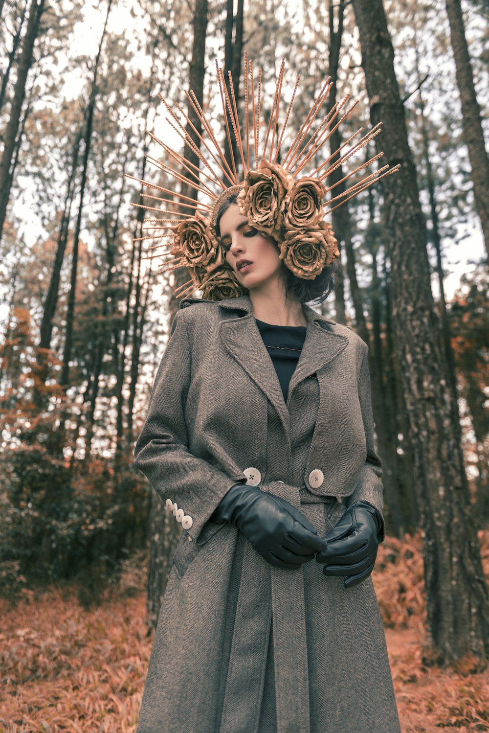 woman in black coat standing near brown trees