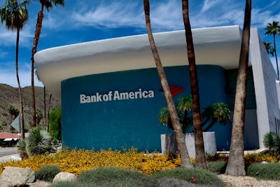a bank of america building with palm trees in front of it