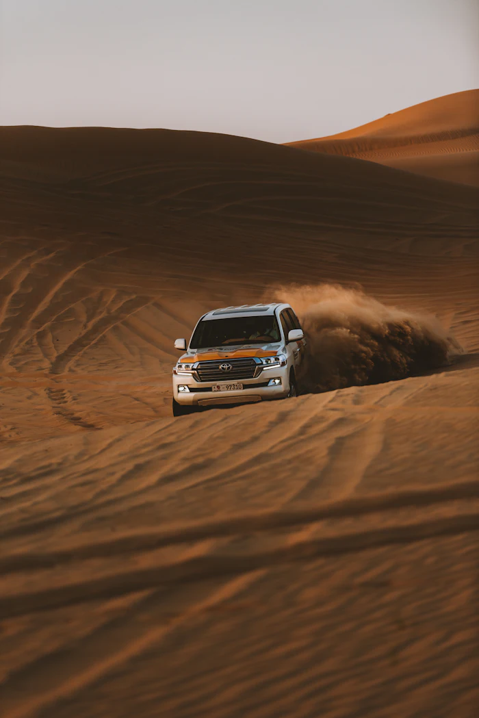 4x4 vehicle dune bashing over sand dunes
