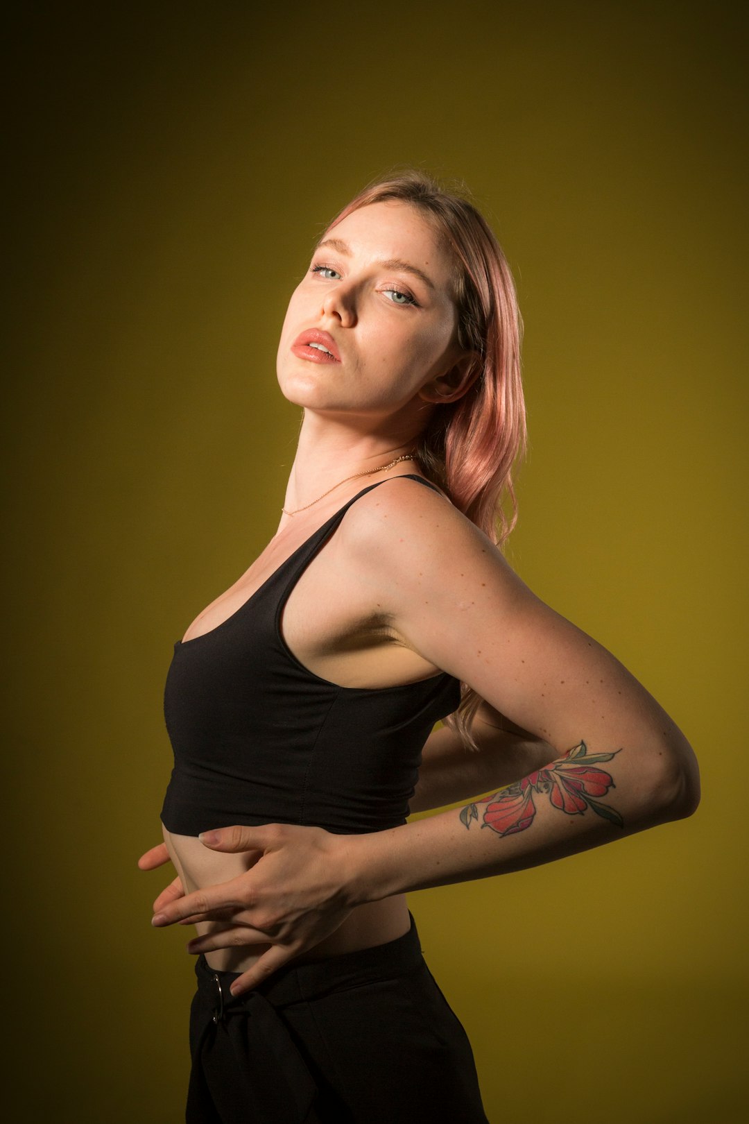 woman in black tank top with tattoo on her left arm