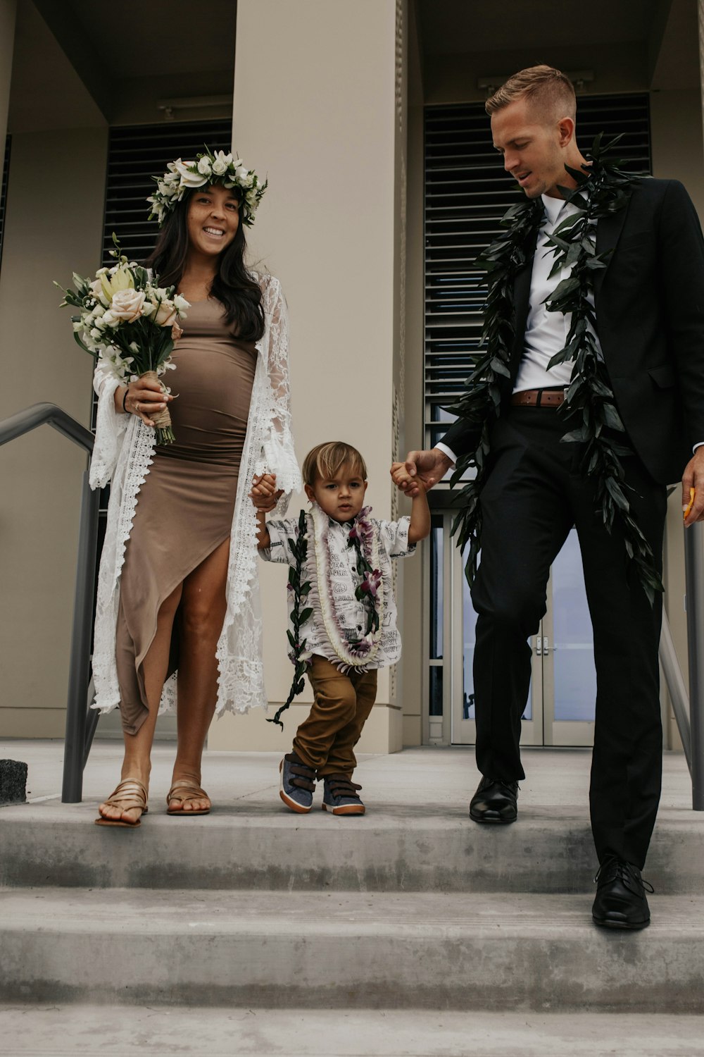 woman in white lace sleeveless dress holding bouquet of flowers